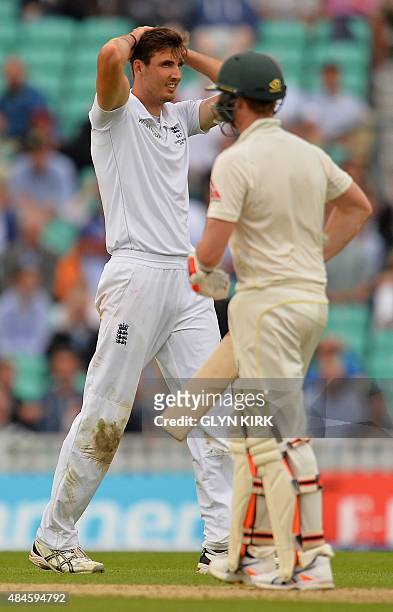 England's Steven Finn reacts after missing a chance to take the wicket of Australia's Steve Smith during the first day of the fifth Ashes cricket...