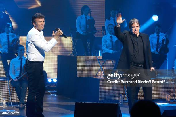 Singer Tony Carreira sings the song 'Une ile' with singer Serge Lama whyle his concert at Palais des Sports on April 12, 2014 in Paris, France.