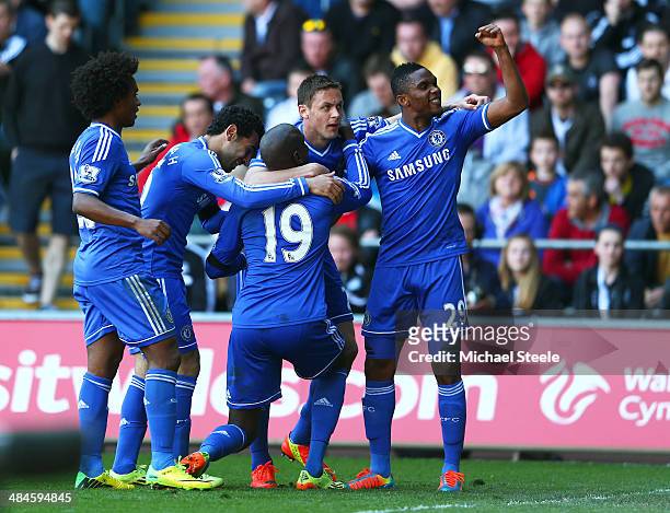 Demba Ba of Chelsea is congratulated by teammates after scoring the opening goal during the Barclays Premier League match between Swansea City and...
