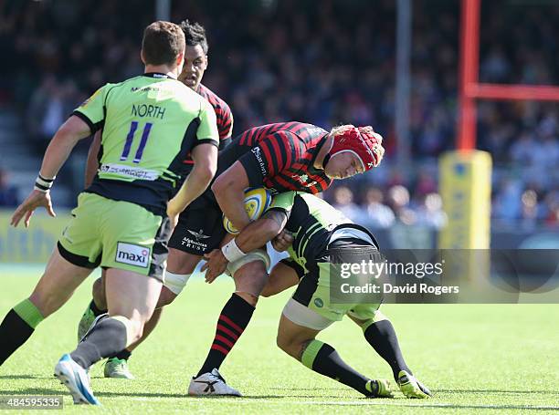 Mouritz Botha of Saracens is tackled by Kahn Fotuali'i during the Aviva Premiership match between Saracens and Northampton Saints at Allianz Park on...