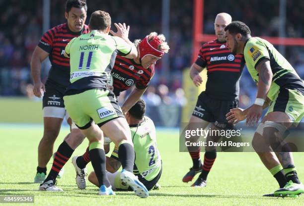 Mouritz Botha of Saracens is tackled by Kahn Fotuali'i during the Aviva Premiership match between Saracens and Northampton Saints at Allianz Park on...