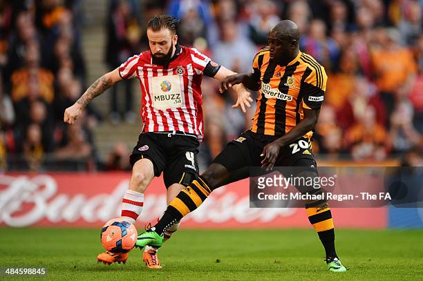 John Brayford of Sheffield United vies with Yannick Sagbo of Hull City during the FA Cup Semi-Final match between Hull City and Sheffield United at...