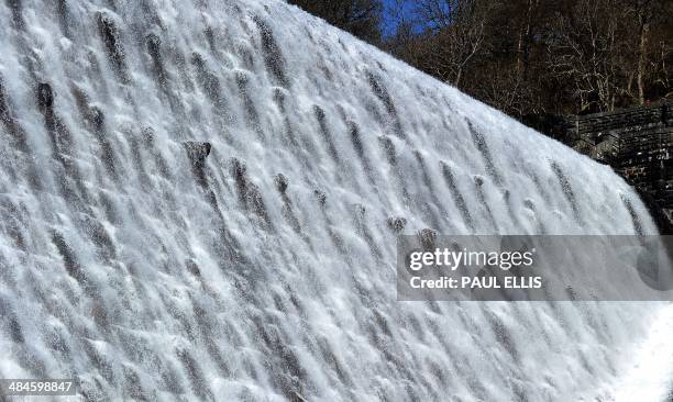 Water cascades down the Pen-y-garreg dam in the Elan Valley in mid-Wales on April 13, 2014. The dam is one of a network of four dams that created...