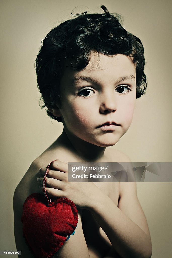 Portrait of child with red heart