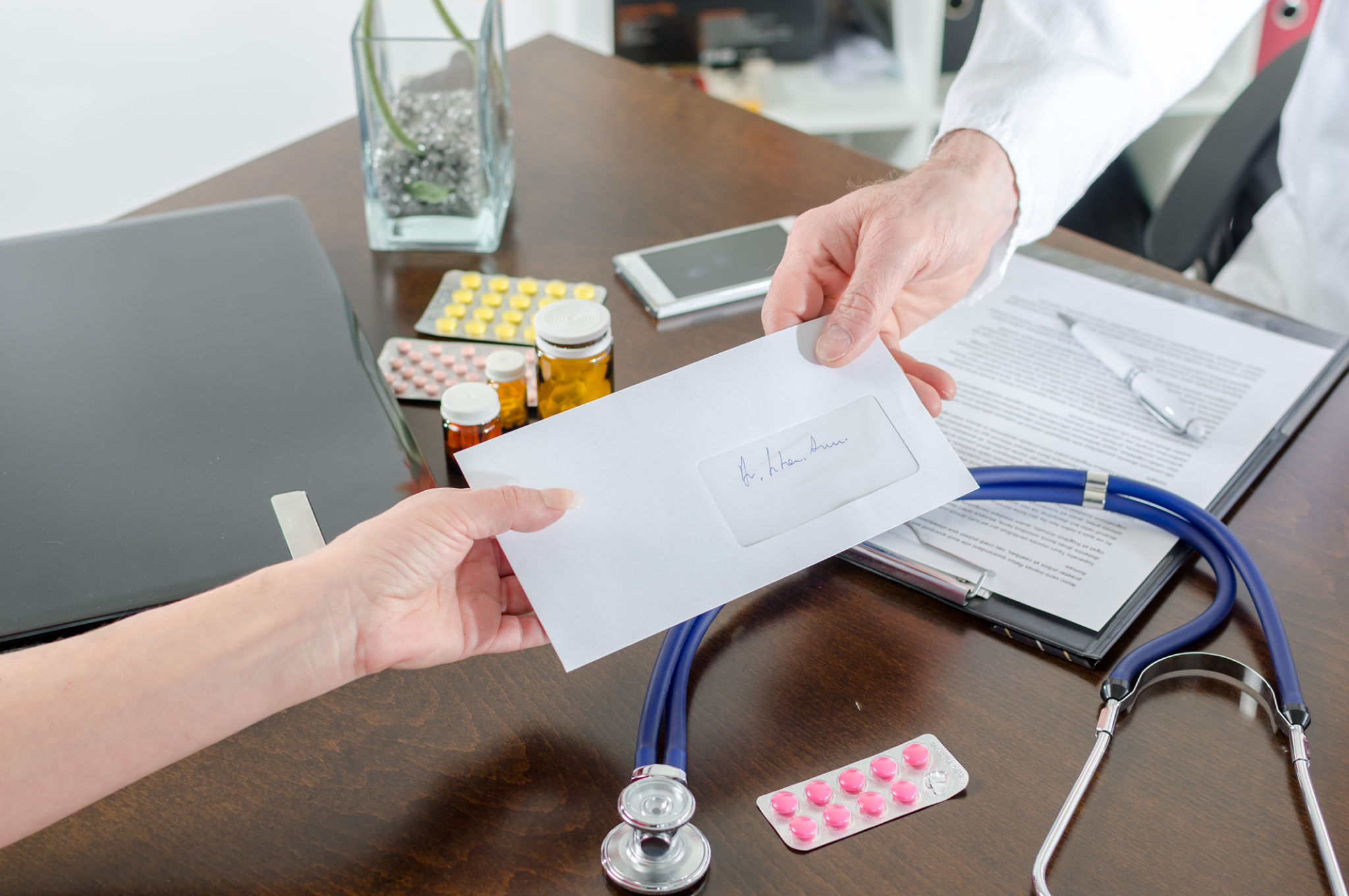 Doctor giving a prescription to his patient Doctor giving a prescription to his patient