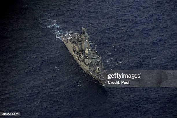 Seen from the Royal New Zealand Airforce P-3K2-Orion aircraft, the Australian ship HMAS Perth is guided into position by the RNZAF aircraft to...