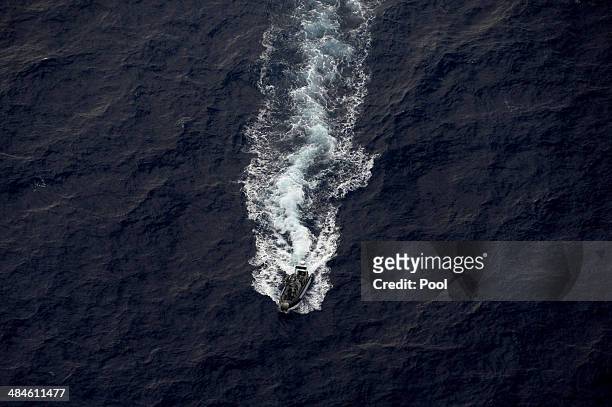 Seen from the Royal New Zealand Airforce P-3K2-Orion aircraft, a RHIB is deployed from the Australian ship HMAS Perth after it was guided into...