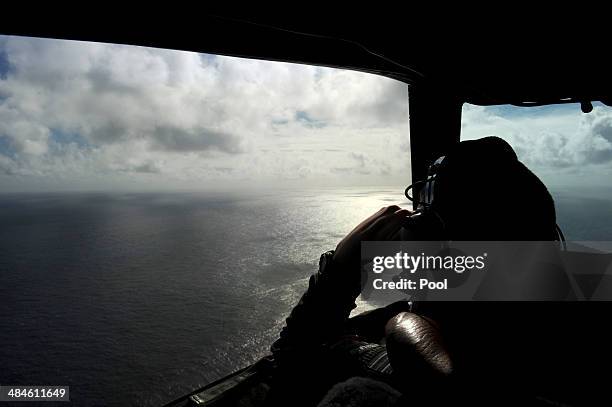 Pilot and aircraft captain, Flight Lieutenant Timothy McAlevey of the Royal New Zealand Airforce P-3K2-Orion aircraft, helps to look for objects...