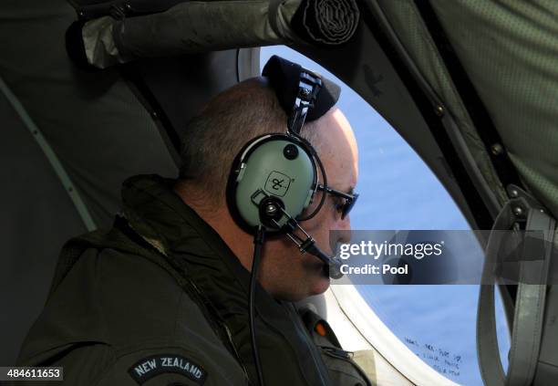 Flight Engineer Chris Poole of the Royal New Zealand Airforce P-3K2-Orion aircraft, helps to look for objects during the search for missing Malaysia...