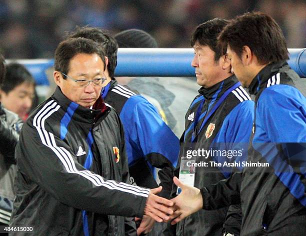 Head coach Takeshi Okada of Japan shakes hands with his staffs after the 0-0 draw in the 2010 FIFA World Cup Aisan Qualifier match between Japan and...