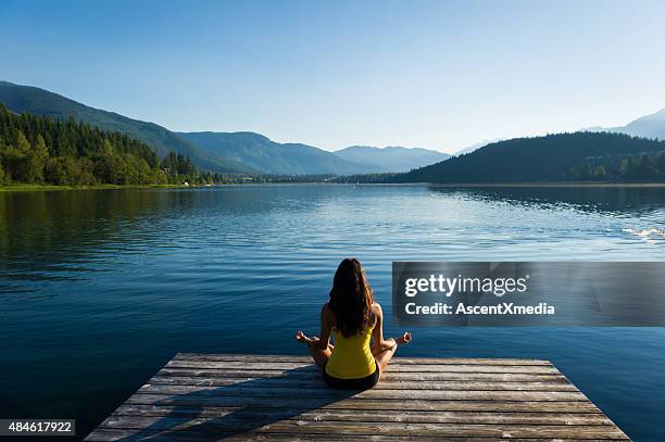 easy pose tranquil lakeside meditation at sunrise - freshwater stock pictures, royalty-free photos & images