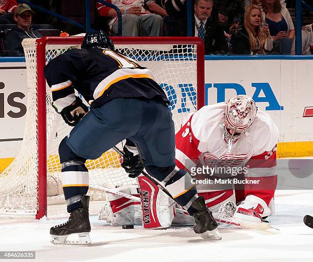Petr Mrazek of the Detroit Red Wings makes a pad save against Keith Aucoin of the St. Louis Blues during an NHL game on April 13, 2014 at Scottrade...