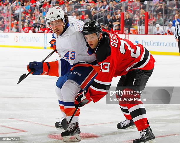 Mike Halmo of the New York Islanders and Tim Sestito of the New Jersey Devils battle for position during the game at the Prudential Center on April...