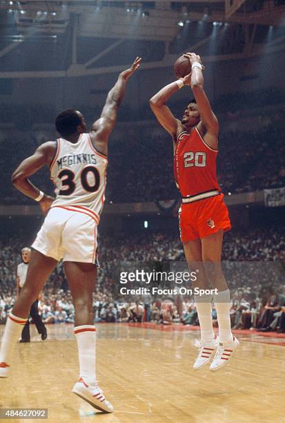 Maurice Lucas of the Portland Trail Blazers shoots over George McGinnis of the Philadelphia 76ers during an NBA basketball game circa 1977 at The...