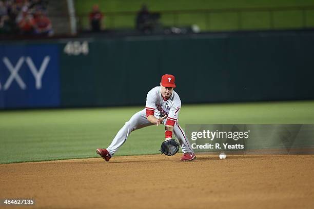 Jayson Nix of the Philadelphia Phillies fields a ground ball throwing out Adrian Beltre of the Texas Rangers at first base in the fourth inning at...