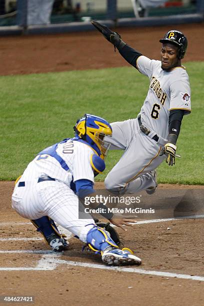 Starling Marte of the Pittsburgh Pirates beats the throw to Jonathan Lucroy of the Milwaukee Brewers during the top of the fourth inning at Miller...