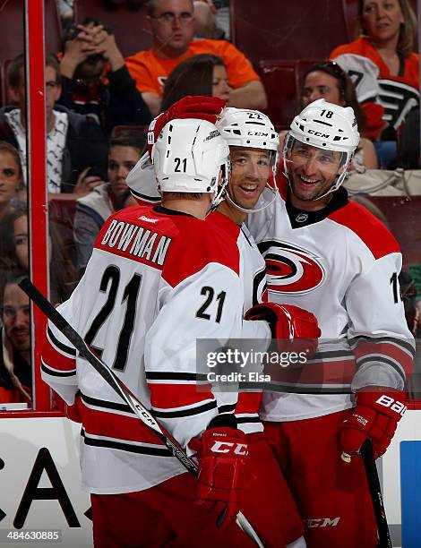 Manny Malhotra of the Carolina Hurricanes is congratulated by teammates Drayson Bowman and Radek Dvorak after Malhotra scored in the first period...