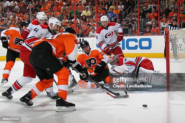 Jay Rosehill, Vincent Lecavalier, and Adam Hall of the Philadelphia Flyers battle for the loose puck in front of goaltender Anton Khudobin of the...