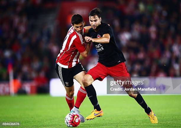 Tim Sparv of Midtjylland challenges for the ball with Shane Long of Southampton during the UEFA Europa League Play Off Round 1st Leg match between...