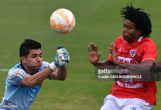 Goalie Kevin Piedrahita, of Colombias Aguilas Doradas, dives to clear a ball in front of Lionard Pajoy of Perus Union Comercio, during their Copa...