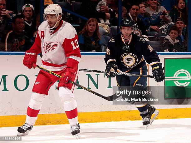 Keith Aucoin of the St. Louis Blues skates against Pavel Datsyuk of the Detroit Red Wings during an NHL game on April 13, 2014 at Scottrade Center in...