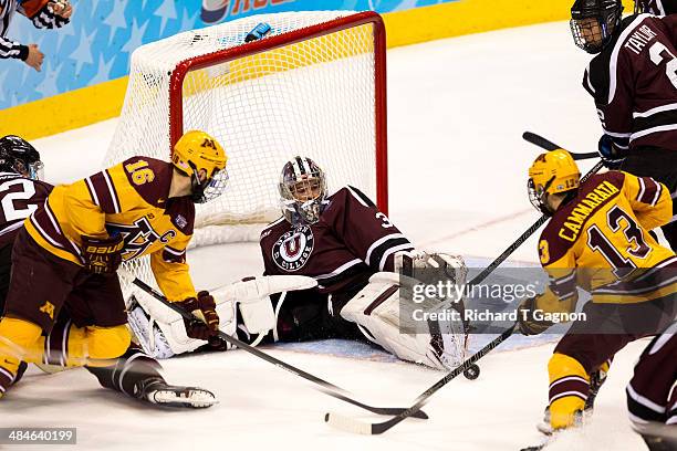 Colin Stevens of the Union College Dutchmen makes a save against the Minnesota Golden Gophers Nate Condon and Taylor Cammarata during the NCAA...