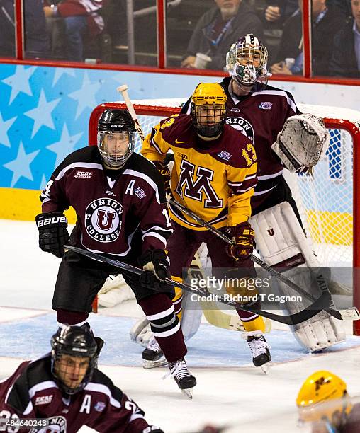 Shayne Gostisbehere and teammate Colin Stevens both of the Union College Dutchmen and Taylor Cammarata of the Minnesota Golden Gophers look for the...