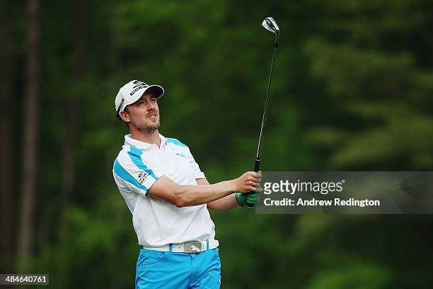 Jonas Blixt of Sweden watches his tee shot on the 12th hole during the final round of the 2014 Masters Tournament at Augusta National Golf Club on...