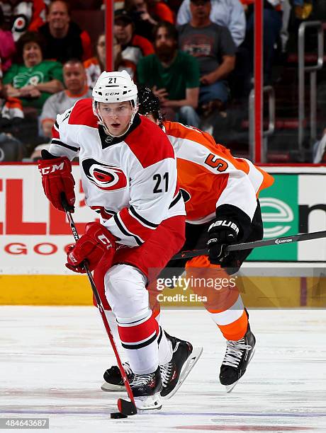 Drayson Bowman of the Carolina Hurricanes takes the puck as Braydon Coburn of the Philadelphia Flyers defends at Wells Fargo Center on April 13, 2014...