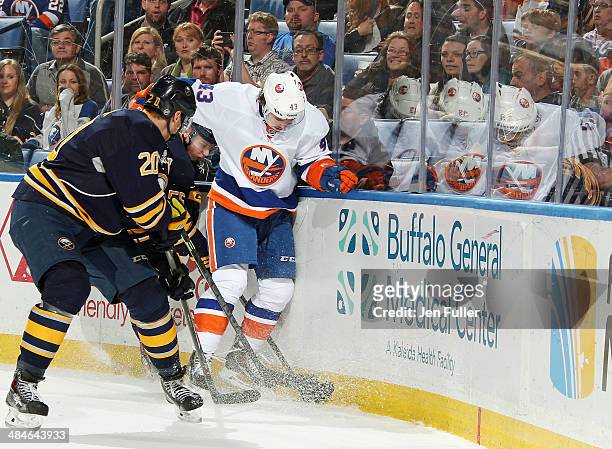 Rasmus Ristolainen and Henrik Tallinder of the Buffalo Sabres battle for the puck along the boards against Mike Halmo of the New York Islanders at...