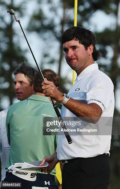 Bubba Watson of the United States celebrates on the 18th green after winning the 2014 Masters Tournament by a three-stroke margin at Augusta National...