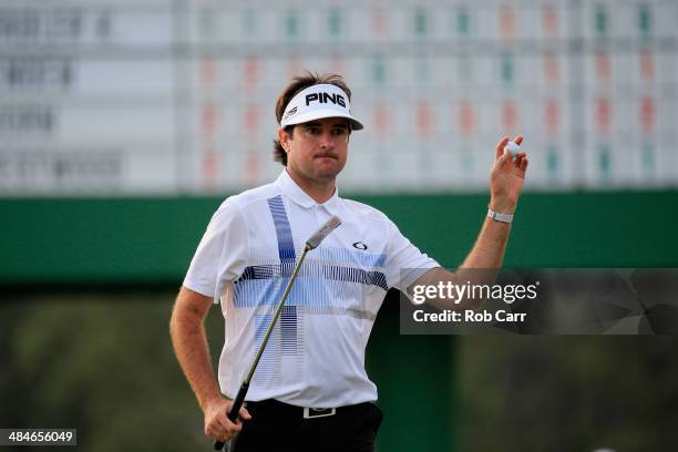Bubba Watson of the United States waves to the gallery on the 17th green after winning the 2014 Masters Tournament by a three-stroke margin at...