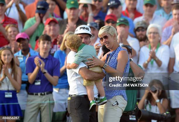 Bubba Watson of the US embraces his son Caleb and wife Angie after putting on the 18th green during the 78th Masters Golf Tournament at Augusta...
