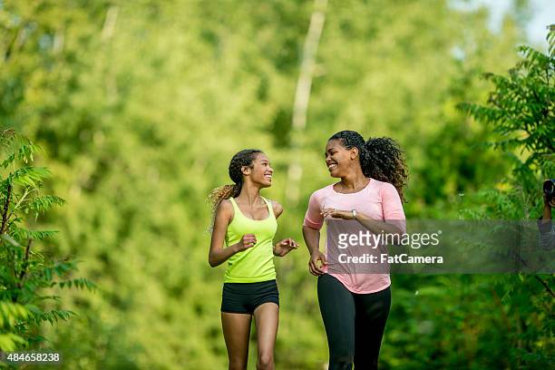 jogging through the woods - mom exercising stock pictures, royalty-free photos & images