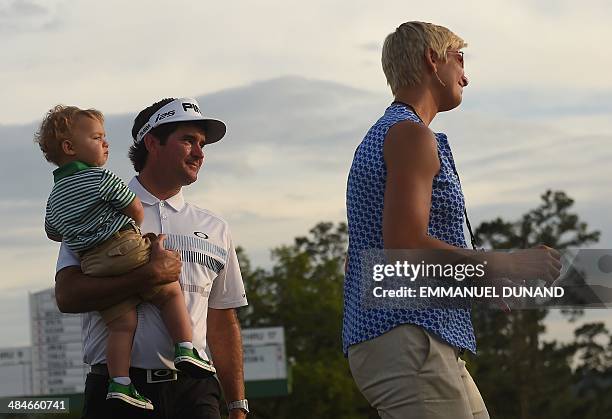 Bubba Watson of the US celebrates with his wife Angie and son Caleb after putting on the 18th green during the 78th Masters Golf Tournament at...