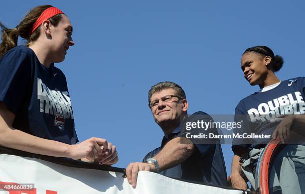 The University of Connecticut women's head coach Geno Auriemma and player Breanna Stewart ride in an open bus during a victory parade April 13, 2014...