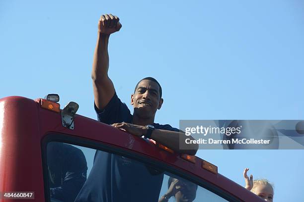 The University of Connecticut men's basketball head coach Kevin Ollie waves to the crowd during a victory parade April 13, 2014 in Hartford,...