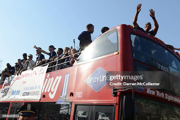 Uconn Huskies head coach Kevin Ollie and his team ride in a victory parade to celebrate their national championship April 13, 2014 in Hartford,...