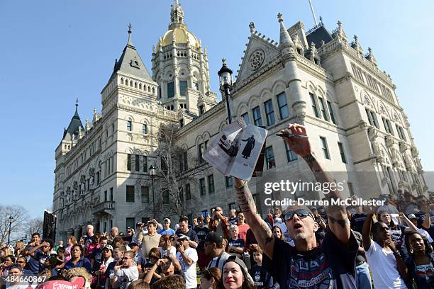 People gather outside the Connecticut State Capitol for a victory parade for the University of Connecticut men's and women's basketball teams April...