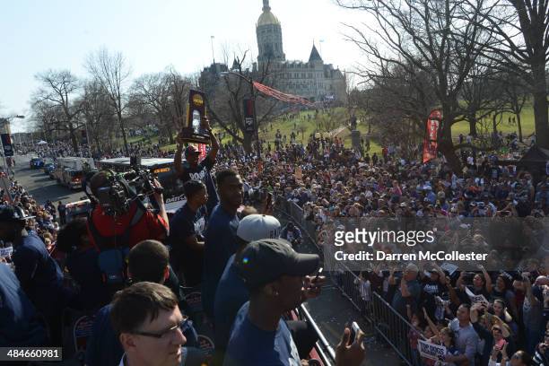 The University of Connecticut's men's basketball team rides in a bus during a victory parade to celebrate their national championships April 13, 2014...