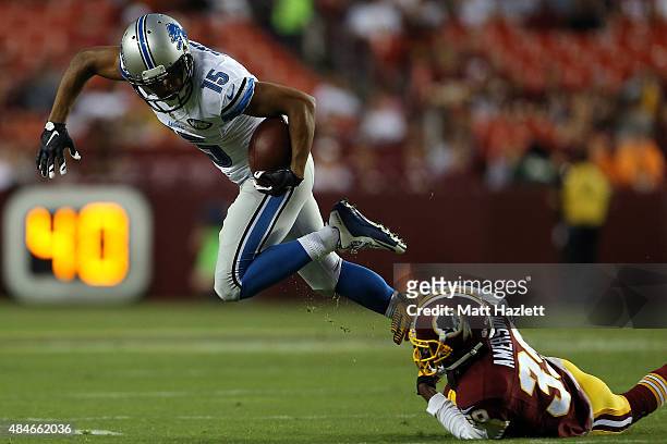 Golden Tate of the Detroit Lions breaks a tackle by David Amerson of the Washington Redskins during a preseason game at FedEx Field on August 20,...
