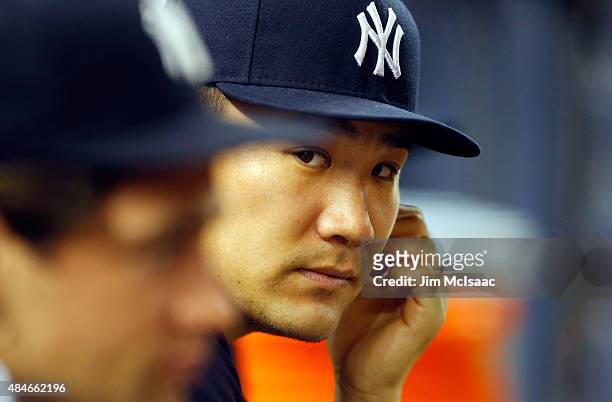 Masahiro Tanaka of the New York Yankees looks on from the dugout in the sixth inning against the Cleveland Indians at Yankee Stadium on August 20,...