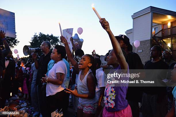 Children gather at the Michael Brown Jr. Memorial on Canfield Drive during a candlelight vigil held in honor of Jamyla Bolden on August 20, 2015 in...
