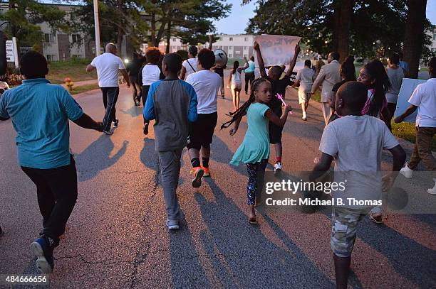 Children march down Canfield Drive during a candlelight vigil held in honor of Jamyla Bolden on August 20, 2015 in Ferguson, Missouri. Jamyla Bolden...