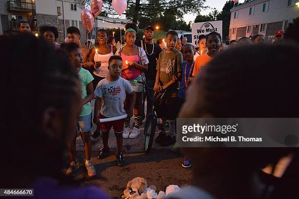 Children gather at the Michael Brown Jr. Memorial on Canfield Drive during a candlelight vigil held in honor of Jamyla Bolden on August 20, 2015 in...