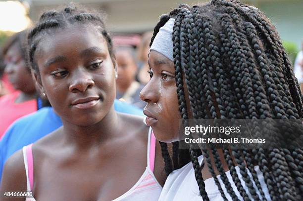 Girl is consoled as she cries during a candlelight vigil held in honor of Jamyla Bolden on August 20, 2015 in Ferguson, Missouri. Jamyla Bolden was...