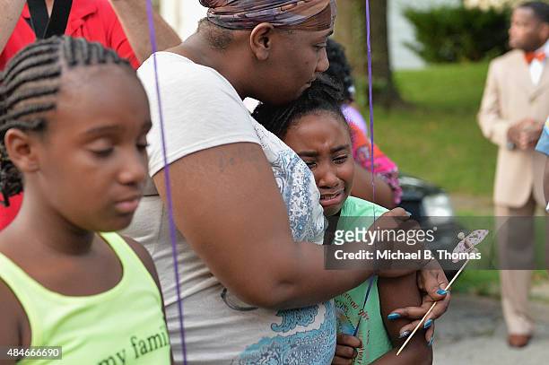 Child is consoled during a candlelight vigil held in honor of Jamyla Bolden on August 20, 2015 in Ferguson, Missouri. Jamyla Bolden was allegedly...