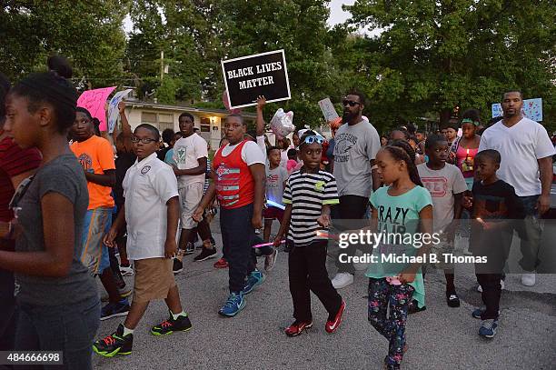 Children march down Ellison Street during a candlelight vigil held in honor of Jamyla Bolden on August 20, 2015 in Ferguson, Missouri. Jamyla Bolden...