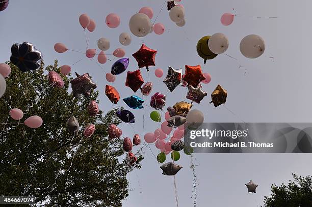 Mourners release balloons during a candlelight vigil held in honor of Jamyla Bolden on August 20, 2015 in Ferguson, Missouri. Jamyla Bolden was...