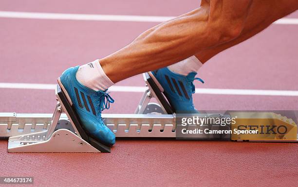 An athlete practices a start from the blocks ahead of the 15th IAAF World Athletics Championships Beijing 2015 at the Beijing National Stadium on...